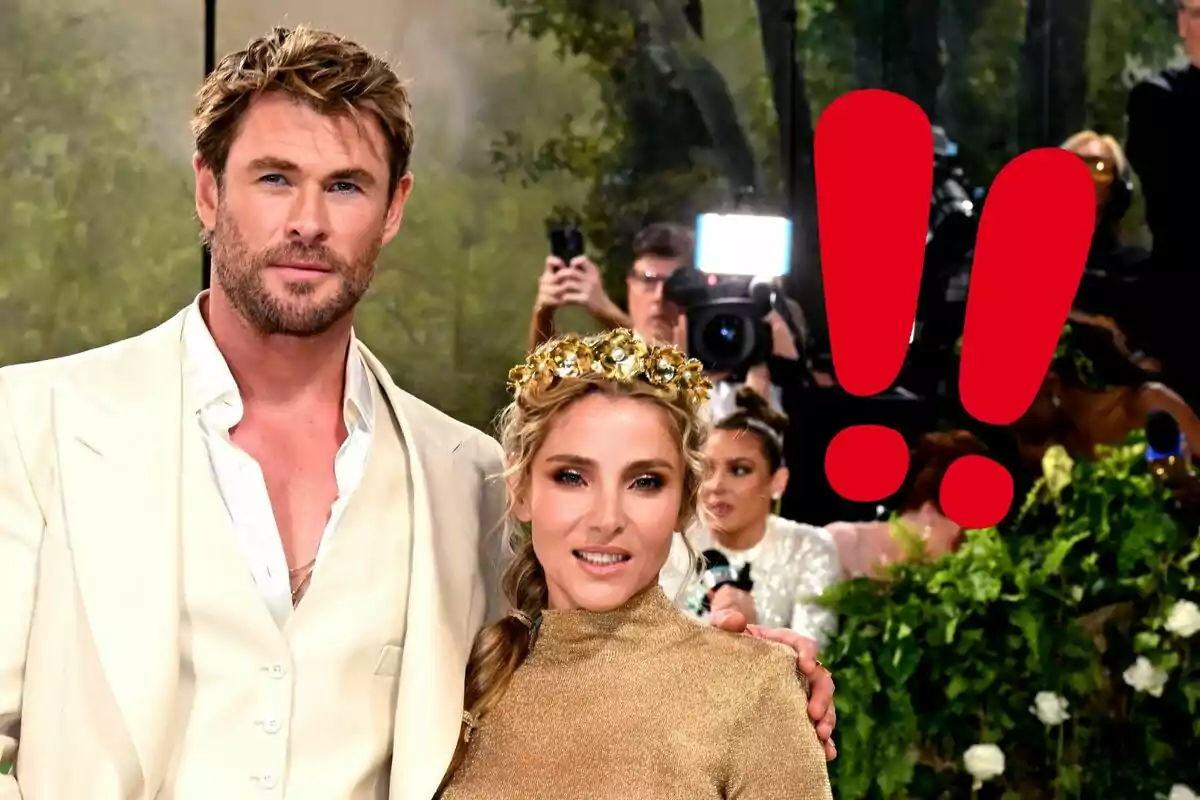 Chris Hemsworth y Elsa Pataky posando elegantemente en un evento con un fondo de fotógrafos y un gran signo de exclamación rojo.