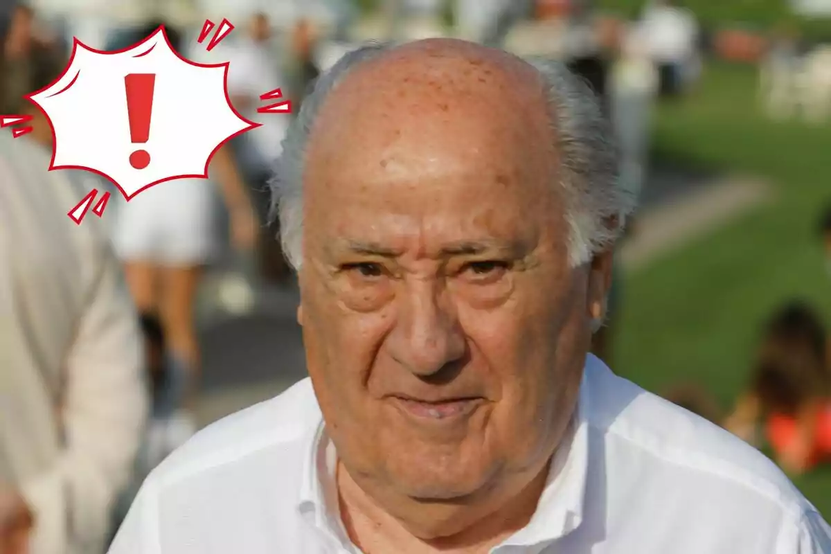 Amancio Ortega con cabello canoso y expresión seria en un entorno al aire libre con un gráfico de exclamación rojo en la esquina.